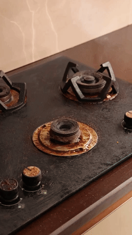 Spraying Scrubsy foam on a stove