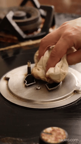 Wiping a kitchen stove clean
